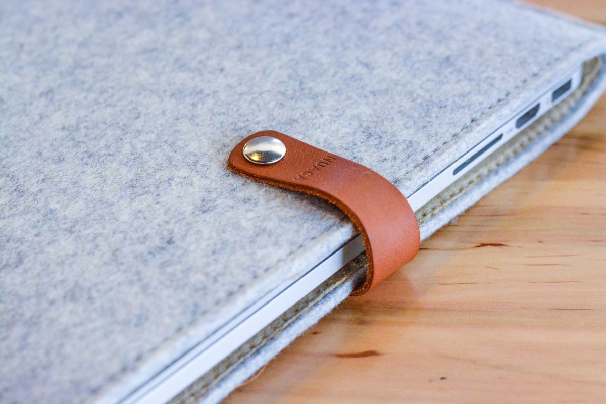 Hard-shell protective laptop case with a laptop tucked inside